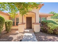 Inviting front entrance with a charming archway, beautiful landscaping and an attractive front door at 3665 E Thames Way, San Tan Valley, AZ 85140