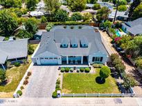 Stunning aerial view of a modern farmhouse with a well-manicured lawn and mature landscaping at 3813 N 37Th St, Phoenix, AZ 85018