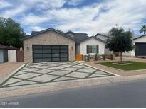 Charming home boasts a modern garage door, patterned driveway, and well-maintained landscaping at 4132 N 42Nd St, Phoenix, AZ 85018