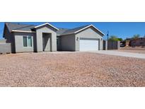 Charming single-story home with a two-car garage and low-maintenance gravel landscaping at 8588 E Edgewood Ave, Mesa, AZ 85208