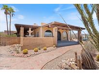 Charming single-story home with desert landscaping, fountain and covered entryway at 9607 E Mckellips Rd, Mesa, AZ 85207