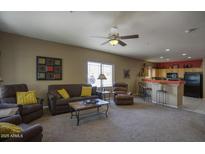 Inviting living room featuring plush seating, a ceiling fan, and seamless flow to the open-concept kitchen at 9750 N Monterey Dr # 71, Fountain Hills, AZ 85268