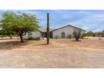 Charming single-story home with a desert landscape, white brick, and a striking saguaro cactus at 10849 E Elmwood St St, Mesa, AZ 85207