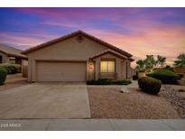 Charming single-story home featuring desert landscaping, a two-car garage, and neutral tones at 11807 E Clinton St, Scottsdale, AZ 85259