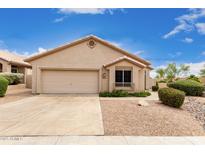 Charming single-story home featuring desert landscaping, a two-car garage, and a neutral color palette at 11807 E Clinton St, Scottsdale, AZ 85259