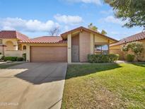 Charming single-Gathering home with a well-maintained lawn, brick accents, and a two-car garage at 12342 S Shoshoni Dr, Phoenix, AZ 85044