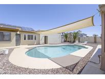 A beautiful backyard pool with lounge chairs and a large awning to provide shade on sunny days at 1285 E Mcmurray Blvd, Casa Grande, AZ 85122
