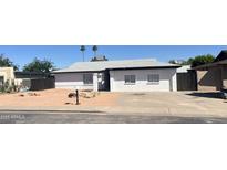 Charming single-story home with a well-maintained front yard and a driveway, ready for new homeowners at 1452 E Emerald Ave, Mesa, AZ 85204