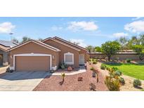 Charming single-story home with desert landscaping, two-car garage, and a neutral color scheme at 15203 N 153Rd Dr, Surprise, AZ 85379