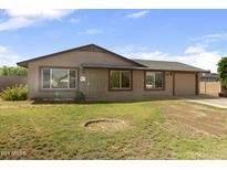 Charming single story home with low maintenance front yard, attached garage, and neutral color palette at 2201 W Wethersfield Rd, Phoenix, AZ 85029
