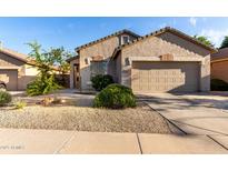 Charming single-story home with a neutral-toned stucco exterior, low maintenance landscaping, and a two-car garage at 2641 E Binner Dr, Chandler, AZ 85225