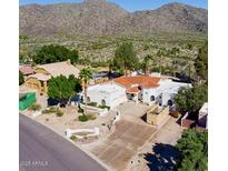 Elegant home featuring a red tile roof, desert landscaping, and a mountain view at 3738 E Kachina Dr, Phoenix, AZ 85044