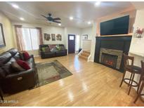 Inviting living room features hardwood floors, fireplace, and comfortable leather sofas at 4805 E Kachina Trl # 25, Phoenix, AZ 85044