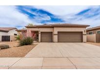 Charming single-story home featuring a two-car garage, desert landscaping, and neutral color palette at 5749 S Dragoon Dr, Chandler, AZ 85249