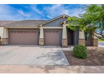 Charming single-Gathering home featuring a three-car garage and stone accents on the front facade at 809 W Coles Rd, Phoenix, AZ 85041