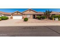 Charming single-story home featuring a well-manicured, low maintenance landscaped front yard and two-car garage at 1147 N Marvin St, Gilbert, AZ 85233
