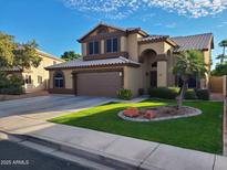 Two-story home with tan exterior, brown trim, landscaped yard, and two car garage at 135 S Abalone Dr, Gilbert, AZ 85233