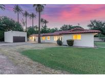 Charming single-story home with desert landscaping and a detached garage, complete with vibrant sunset backdrop at 1532 W Northern Ave, Phoenix, AZ 85021