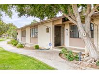Charming single-story home featuring well-maintained landscaping, a security door and an inviting walkway at 1550 N Stapley Dr # 6, Mesa, AZ 85203