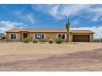Charming single-story home boasts desert landscaping, a neutral color scheme, and an attached two car garage at 16415 W Oyer Ln, Surprise, AZ 85387
