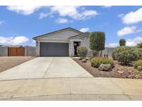 Charming single-story home with a two-car garage and desert landscaping at 18100 W College Dr, Goodyear, AZ 85395