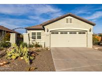 Charming single-story home featuring a two car garage and desert landscaping at 19667 N 260Th N Ln, Buckeye, AZ 85396