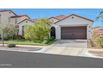 Charming single-story home with a well-manicured lawn, tile roof, and a two-car garage at 20510 W White Rock Rd, Buckeye, AZ 85396