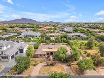 Expansive aerial view showcases lush landscaping, circular driveway, and mountain views at 2285 E Plum St, Gilbert, AZ 85298