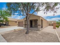 Charming single-story home featuring a desert-landscaped yard and covered porch area at 23613 W Mobile Ln Ln, Buckeye, AZ 85326
