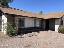 Charming single-story home featuring desert landscaping, brick accents and modern windows at 3102 N Woodburne Dr, Chandler, AZ 85224