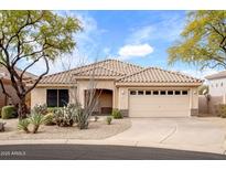 Charming single-story home featuring a tile roof, desert landscaping, and a two-car garage at 35360 N 93Rd Way, Scottsdale, AZ 85262
