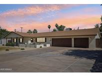 Charming single story home with a three car garage and beautiful desert landscaping and front courtyard at 4920 E Osborn Rd, Phoenix, AZ 85018