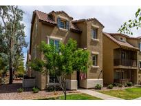 Charming two-story home showcasing a red tile roof and a lovely landscaped front yard at 5612 S 21St Pl, Phoenix, AZ 85040