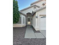 Traditional style home featuring an arched entry way and neutral colored facade at 60 S Willow Creek St, Chandler, AZ 85225