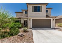 Charming two-story home featuring a neutral color palette and a two-car garage with a concrete driveway at 6305 W Pleasant Oak Ct, Florence, AZ 85132