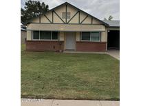 Charming bungalow with brick accents, awning, and well-manicured lawn at 10201 N 97Th Ave # B, Peoria, AZ 85345