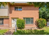Charming brick townhouse with lush green lawn and colorful bushes at 1301 N 44Th St, Phoenix, AZ 85008