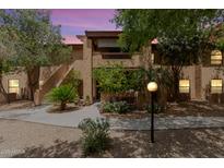 Charming stucco condo with beautiful landscaping and a private balcony in a vibrant community at 1351 N Pleasant Dr # 2051, Chandler, AZ 85225
