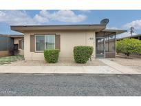 Cozy single-story home featuring a screened entryway and low maintenance front yard landscaping at 13611 N 98Th Ave # D, Sun City, AZ 85351