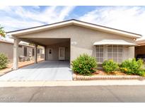 Charming single-story home with a covered carport and manicured landscaping at 1784 E Torrey Pines Ln, Chandler, AZ 85249