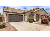 Charming single-story home with a well-maintained front yard, desert landscaping, and a two-car garage at 18614 E Oriole Way, Queen Creek, AZ 85142