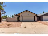 Charming single-level home with a two-car garage and desert landscaping at 2164 S Estrella Cir, Mesa, AZ 85202