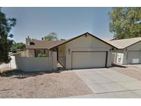 Charming single-story home featuring a private gated entrance and an attached two-car garage at 2164 S Estrella Cir, Mesa, AZ 85202