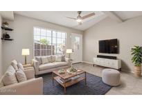 Bright living room featuring a large window, ceiling fan and comfortable furniture at 2301 E University Dr # 172, Mesa, AZ 85213