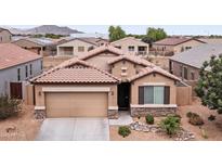 Charming single-Gathering home featuring a two-car garage, desert landscaping, and a tile roof in a residential neighborhood at 23690 W Ripple Rd, Buckeye, AZ 85326