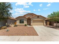 Charming single-story home featuring a well-maintained front yard and a two-car garage at 43884 W Kramer Ln, Maricopa, AZ 85138