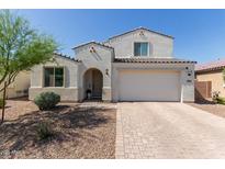 Charming two-story home with a two-car garage and desert landscaping at 5330 W Thresher Way, Laveen, AZ 85339