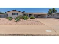 Charming single-story home featuring desert landscaping, a carport, and fresh, white paint in a well-maintained neighborhood at 701 N 55Th Pl, Mesa, AZ 85205