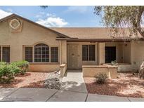 Charming single-story home featuring a landscaped front yard with desert landscaping, textured stucco, and a covered entryway at 8140 N 107Th Ave # 287, Peoria, AZ 85345