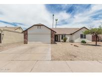 Charming single-story home with a two car garage and low maintenance desert landscaping in front at 11021 N 55Th Dr, Glendale, AZ 85304